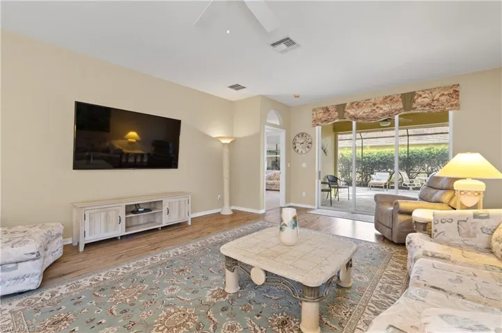 Living room featuring hardwood / wood-style flooring and ceiling fan