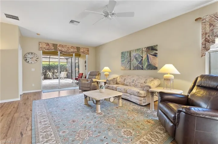 Living room with ceiling fan and light wood-type flooring