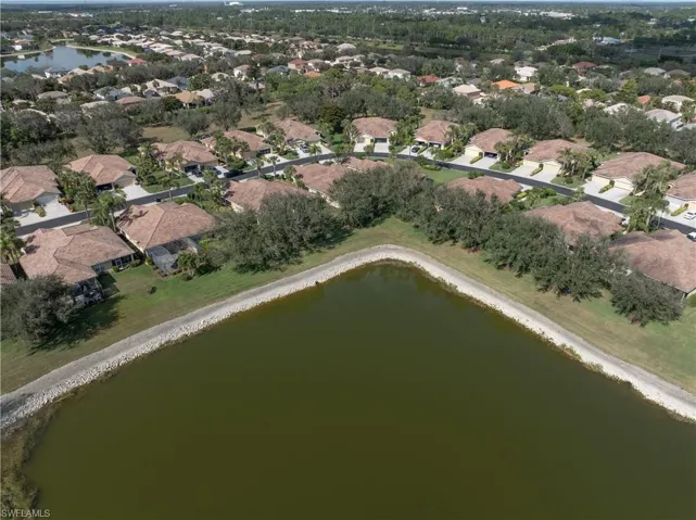 Birds eye view of property with a water view