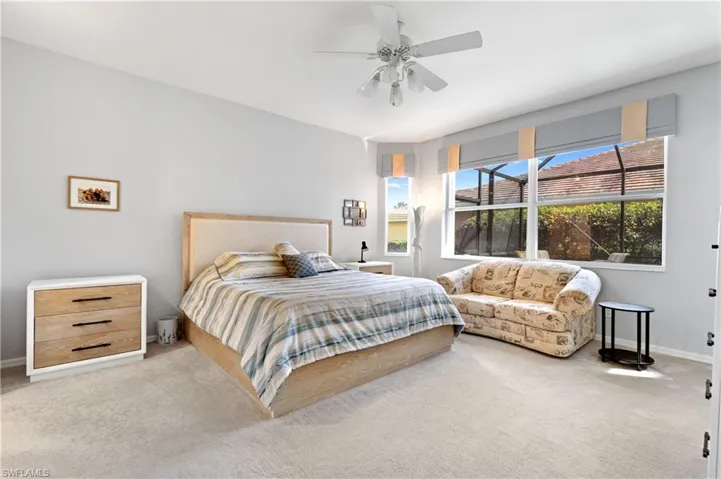 Carpeted bedroom with ceiling fan