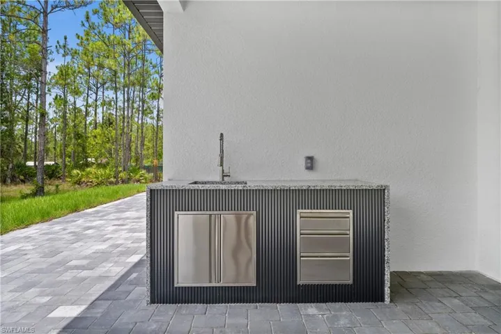 Detailed view of a sink and stucco siding