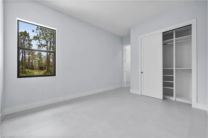 Unfurnished bedroom featuring baseboards and a closet