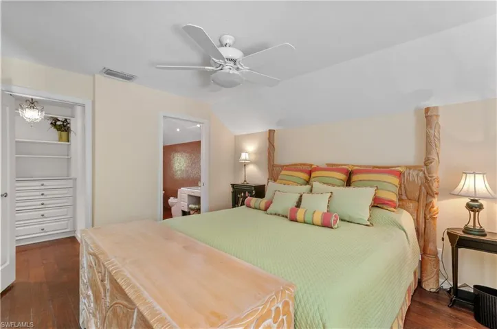 2nd floor main Bedroom featuring vaulted ceiling, ceiling fan, dark wood-style floors, and ensuite bathroom and many built in-storage