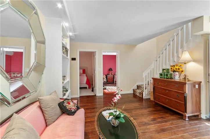 Living room featuring stairs and dark wood finished floors