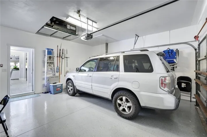 FGarage features epoxy flooring, mounted storage, and direct access into the home.