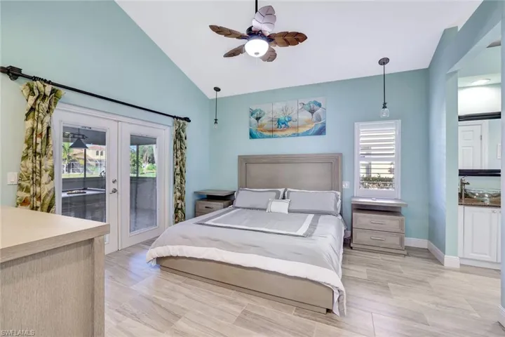Primary bedroom with vaulted ceilings, lanai access and large windows for natural light.