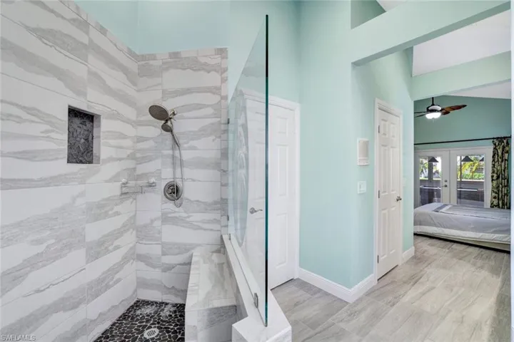 Large walk-in shower with custom tile.