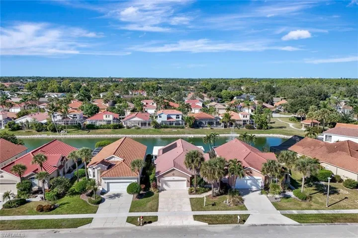 Aerial view of the home and surrounding neighborhood, highlighting the waterfront setting.