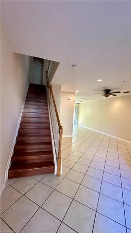 Stairs featuring tile patterned floors, a ceiling fan, and recessed lighting