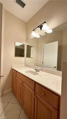 Bathroom featuring vanity and light tile patterned floors
