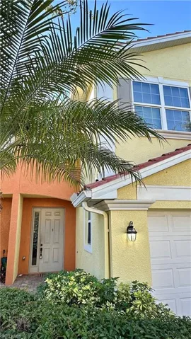 Entrance to property featuring stucco siding and a garage