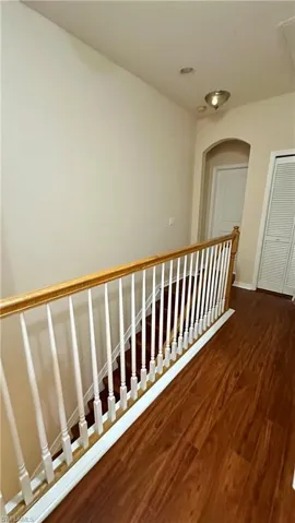 Staircase featuring wood finished floors