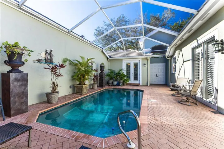 Swimming pool featuring a patio area, french doors