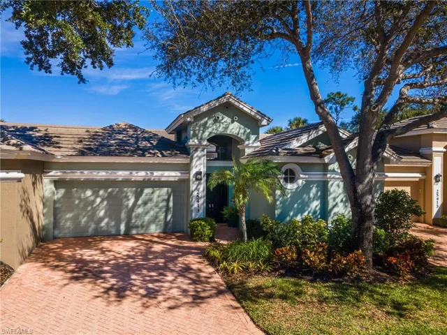 Mediterranean / spanish-style home featuring stucco siding, decorative driveway, and a garage