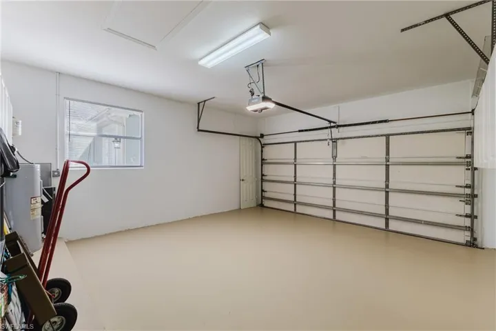 Garage with electric water heater and a garage door opener
