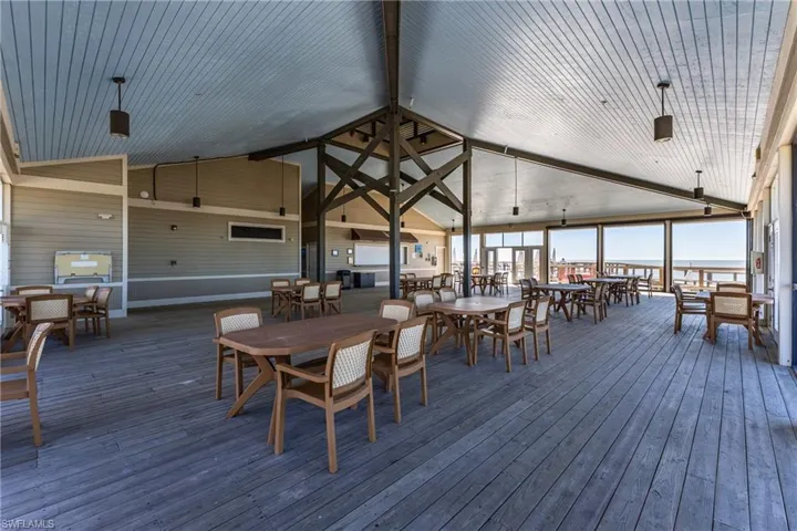 Wooden deck with outdoor dining space at the private beach pavillion