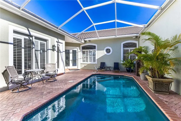 Outdoor pool and patio area screened