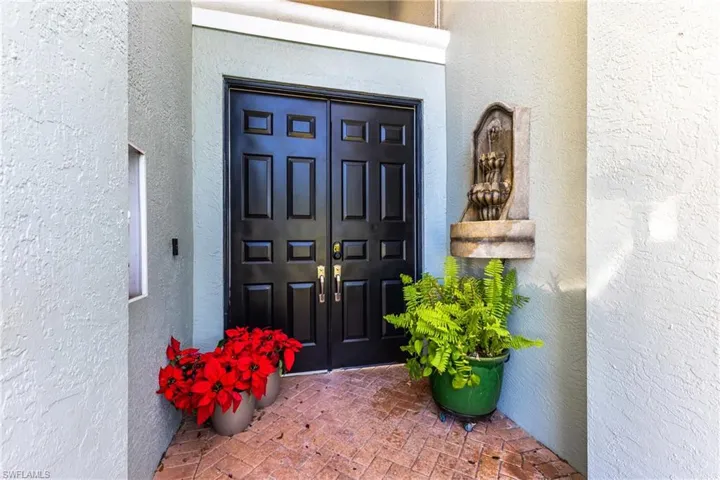 View of exterior entry featuring stucco siding