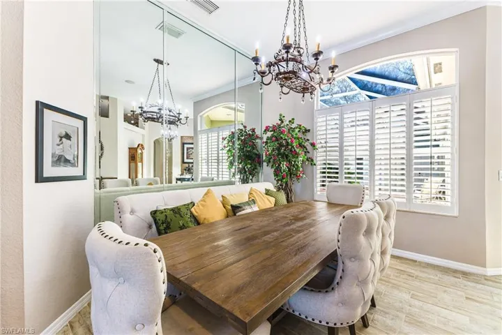 Dining area featuring crown molding, a chandelier, and light wood-style floors
