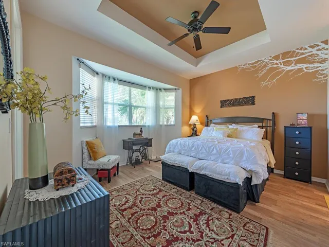 Lovely lake views from the spacious primary bedroom  with its high ceilings and ensuite bathroom.