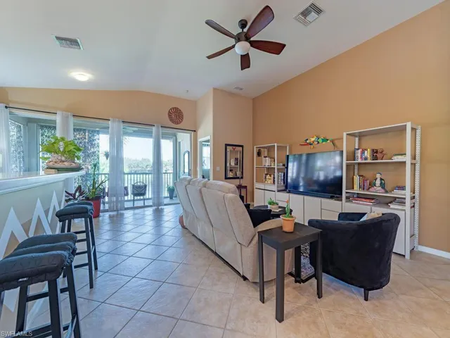 High ceilings makes this living room area so spacious with views of the lake fountain.