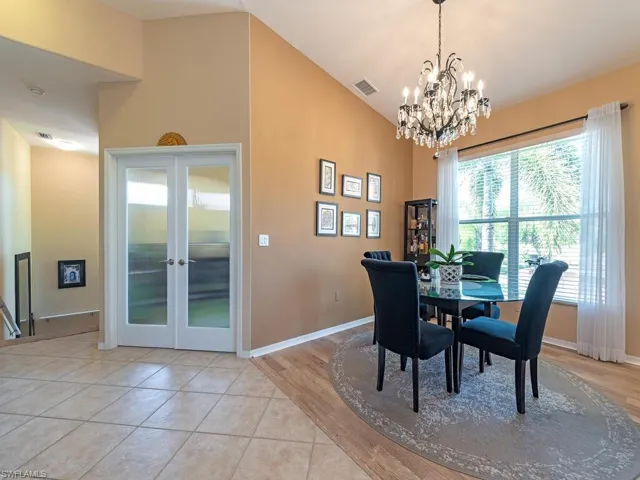 As you enter this second floor residence, the open floor plan with views of the lake will make you feel right at home!  A den/flex room with glass doors is to your left along with the dining area  and loads of natural light.