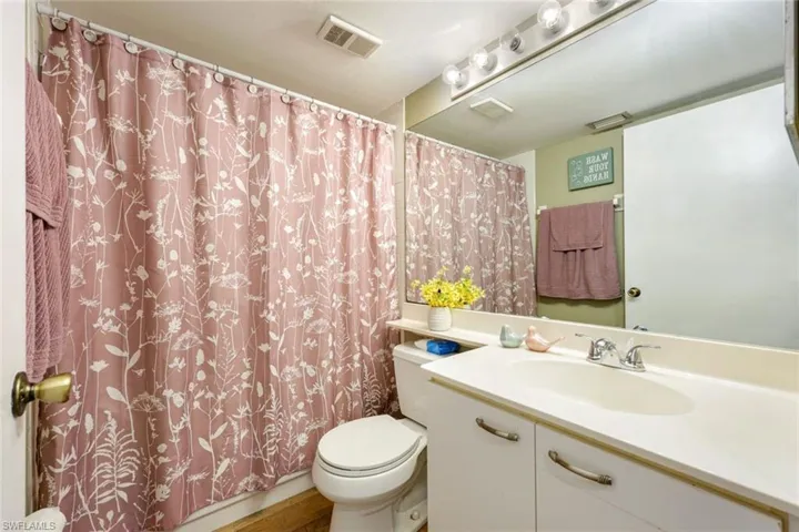 Bathroom with vanity and shower / bath combo with shower curtain