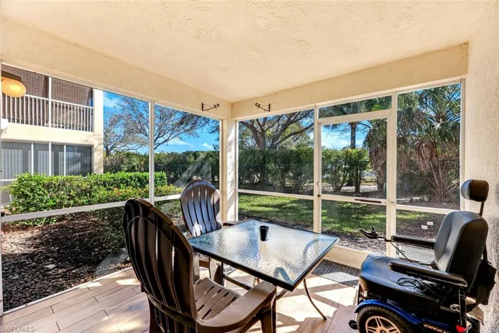 Sunroom with outdoor dining area