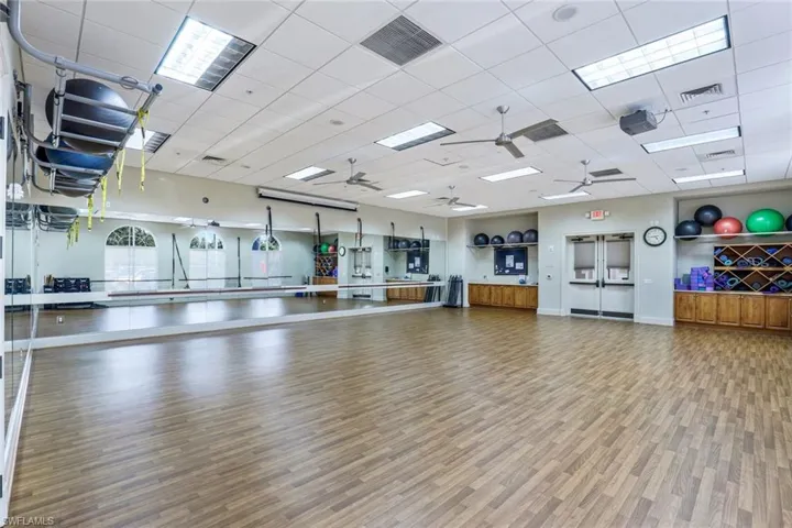 Exercise area with a drop ceiling and ceiling fan