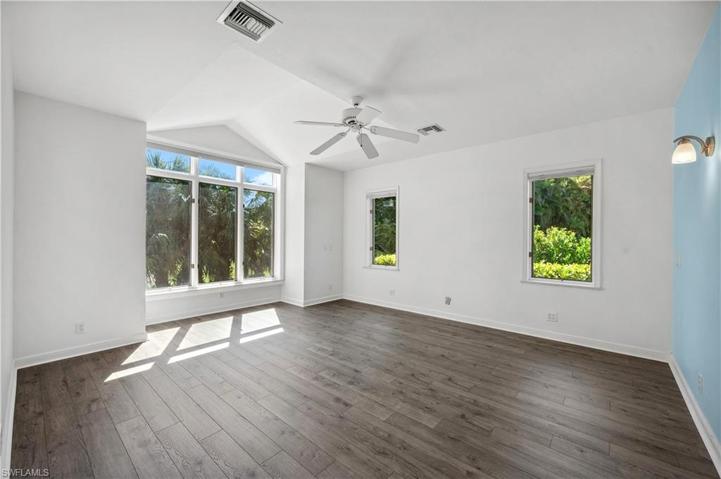 Large primary bedroom with view of the lake & backyard.