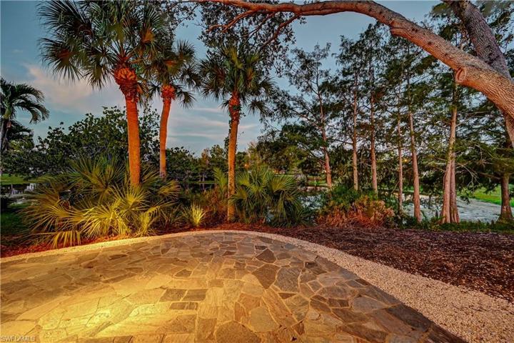 Landscape lighting highlights the extensive plantings.