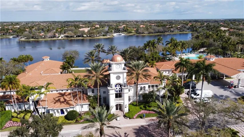 Birds eye view of property with a water view