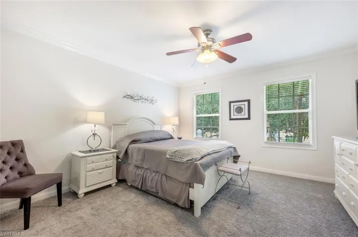 Bedroom featuring carpet floors, ceiling fan, and crown molding