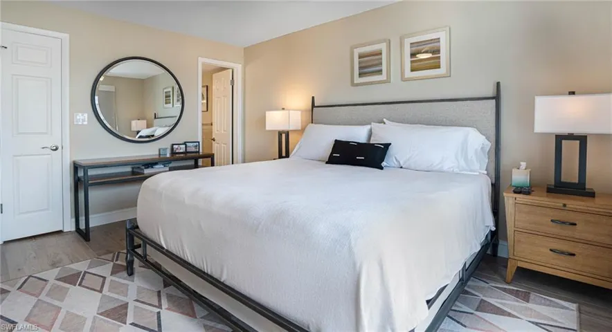 Bedroom with dark hardwood / wood-style flooring