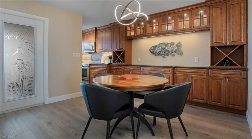 Dining space featuring light hardwood / wood-style floors and an inviting chandelier