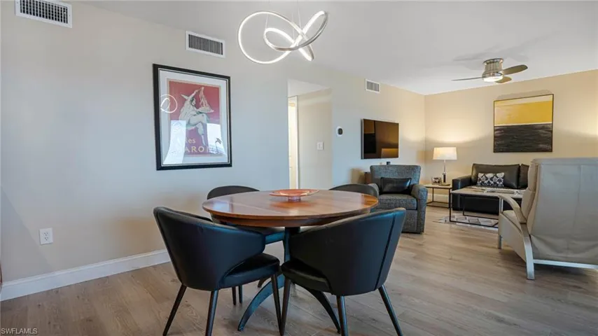 Dining room with ceiling fan and light hardwood / wood-style floors