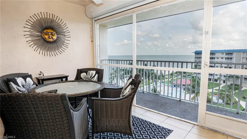 Sunroom / solarium with plenty of natural light and a water view