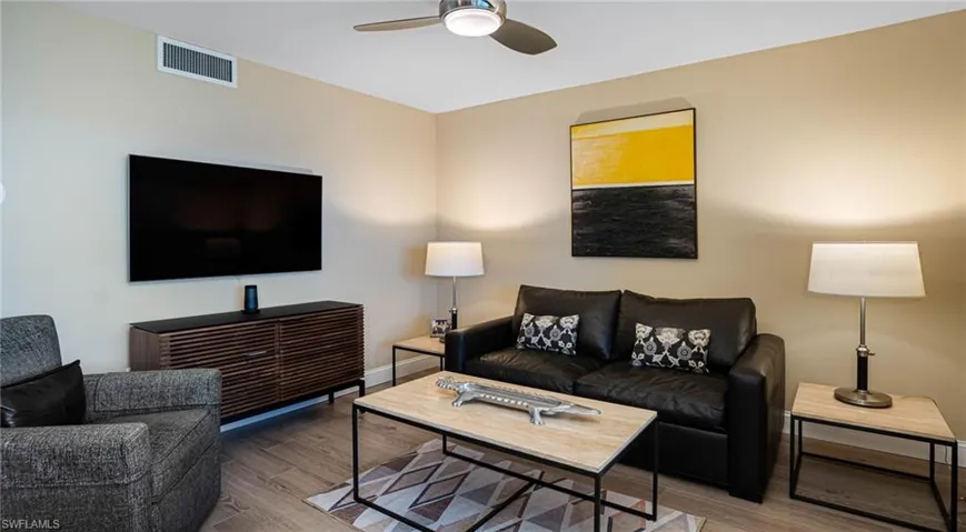 Living room with hardwood / wood-style floors and ceiling fan