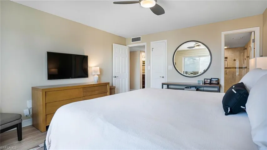 Bedroom with ceiling fan and light wood-type flooring