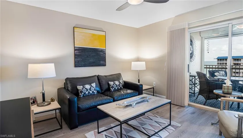 Living room with ceiling fan and hardwood / wood-style floors
