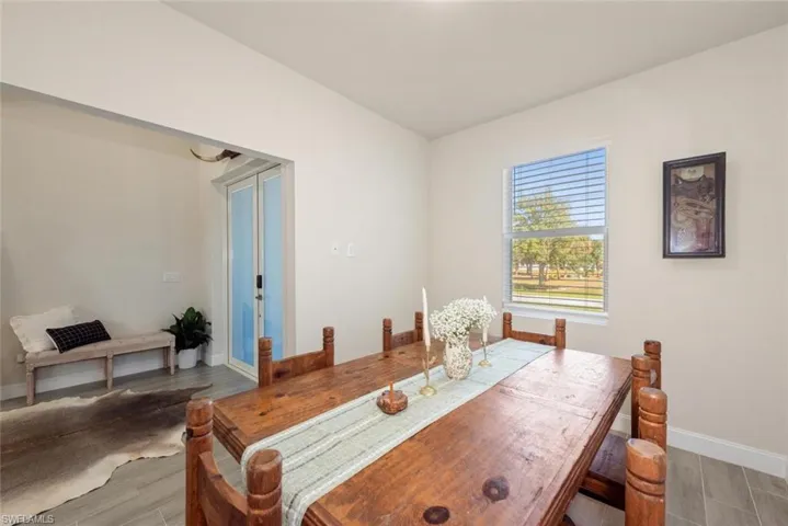 Dining space with wood tiled floors and french doors