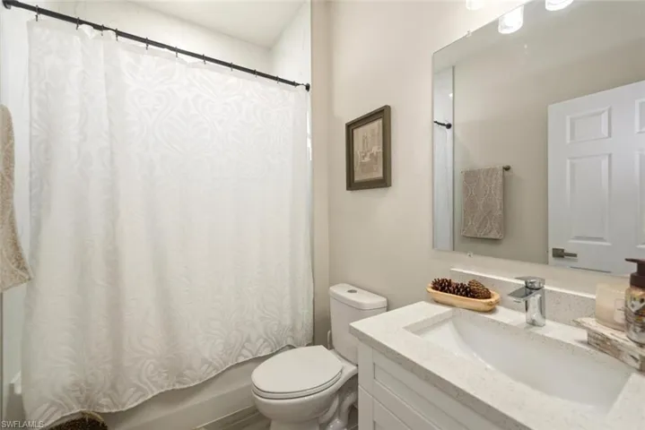 Full bath with vanity and shower / bath combination with curtain