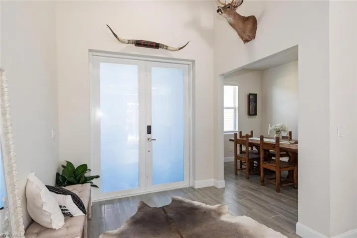 Foyer entrance featuring wood tiled floors and french doors