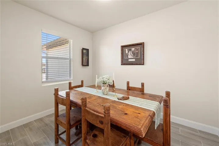 Dining space with wood finish floors and baseboards