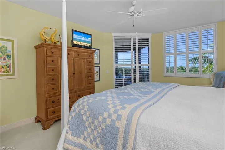 Primary bedroom with natural light from lanai and large picture window.