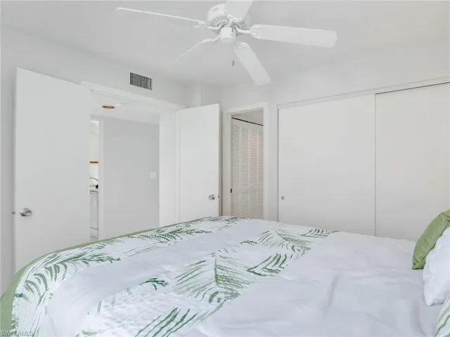 Bedroom with ceiling fan and two closets