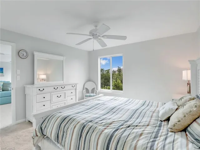 Bedroom featuring light carpet and ceiling fan