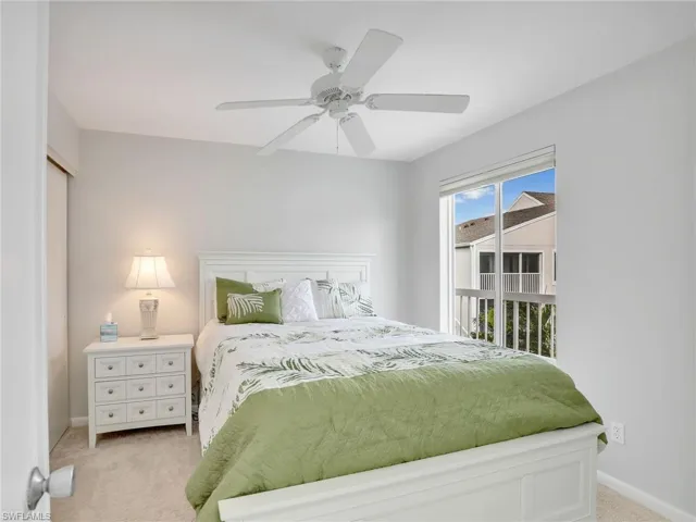 Carpeted bedroom with ceiling fan