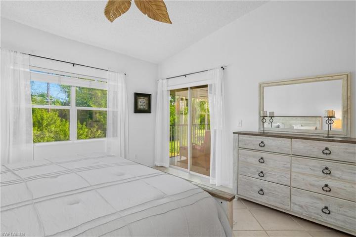 Master bedroom is located at the back of the condo for additional privacy, & includes a slider to step outside onto the screened in lanai.