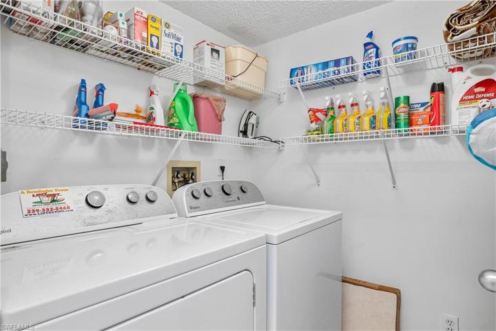 Laundry room includes additional shelving.